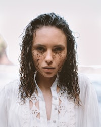 a young woman with freckles on her face